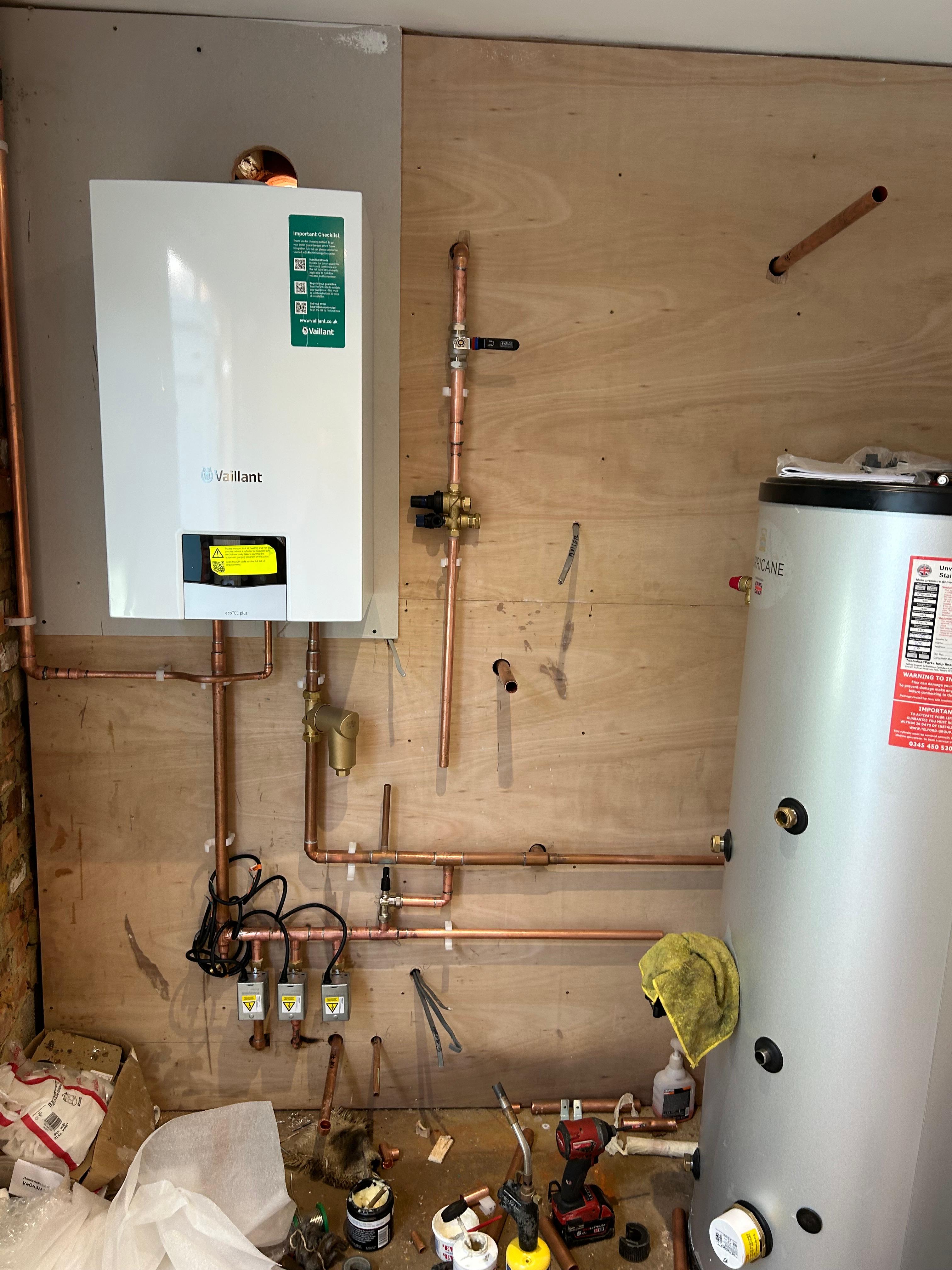 Professional boiler installation — wall-hung unit with neat copper pipework
