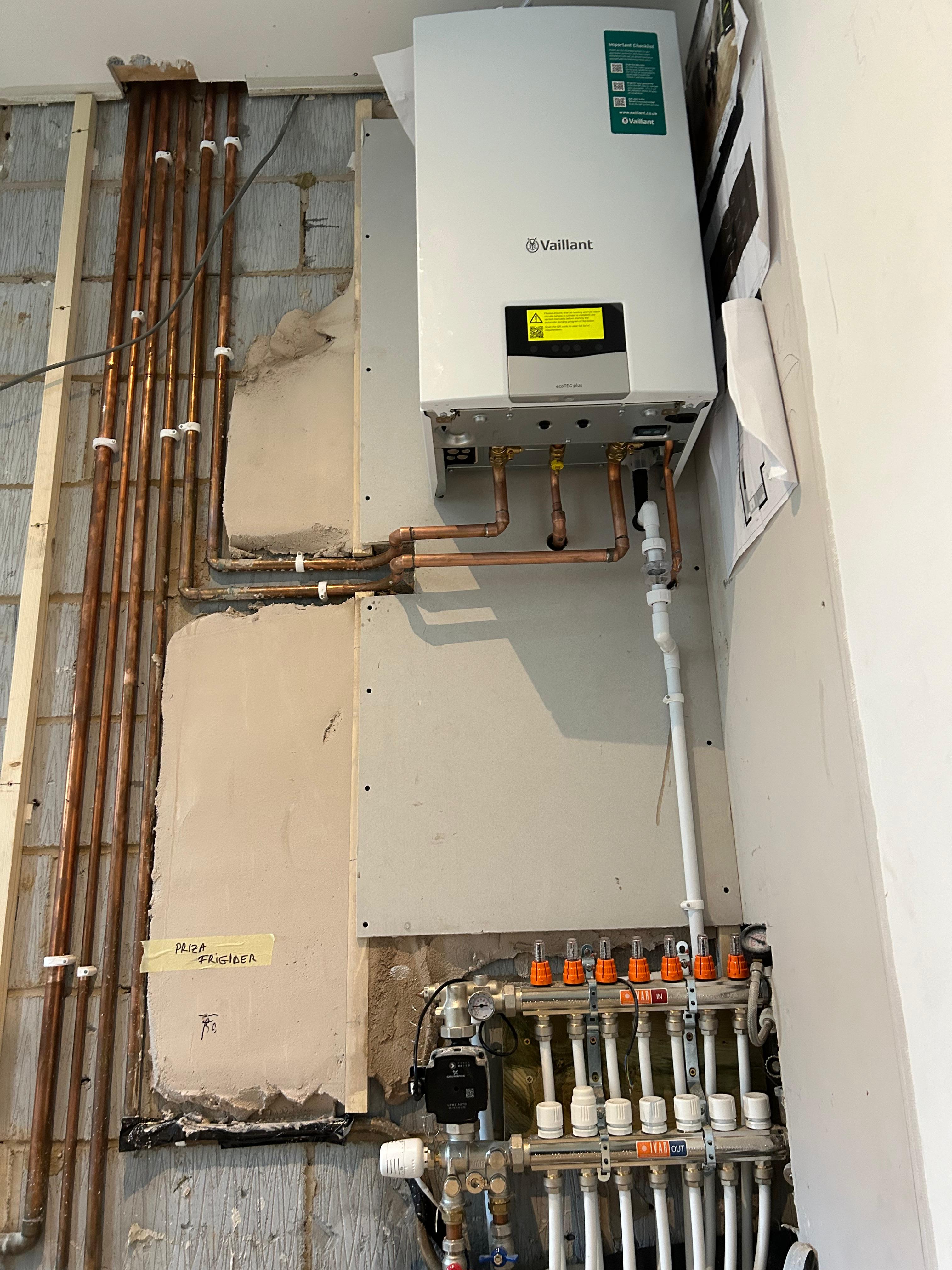 Vaillant combi boiler with copper pipework and heating manifold — professional installation