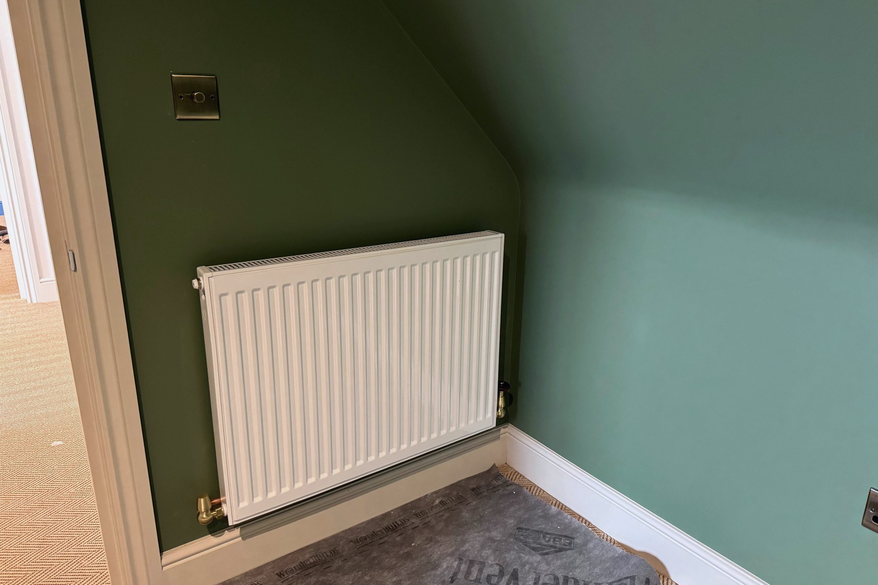 New white panel radiator with quality valves, installed and finished in a refurbished room